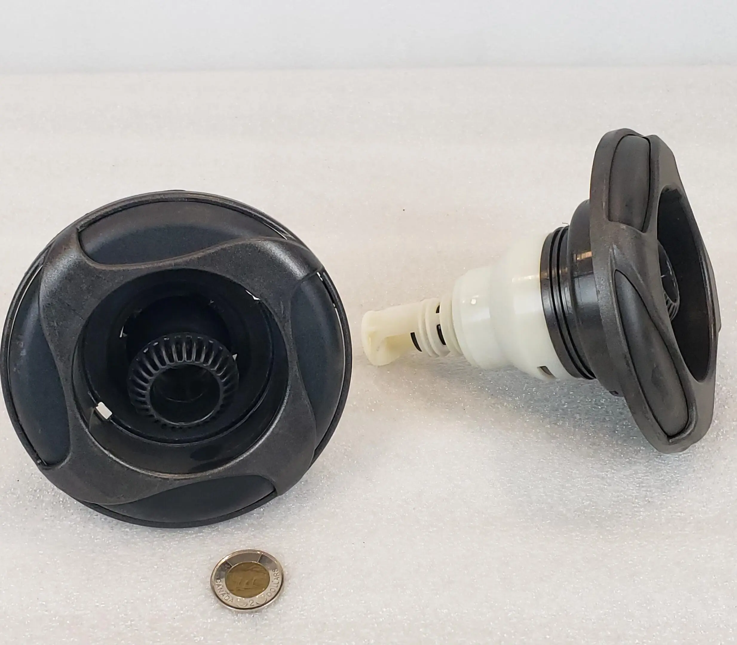 A black and white camera lens with a penny