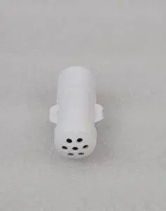 A white object with black dots on it.