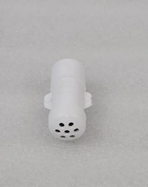 A white object with black dots on it.