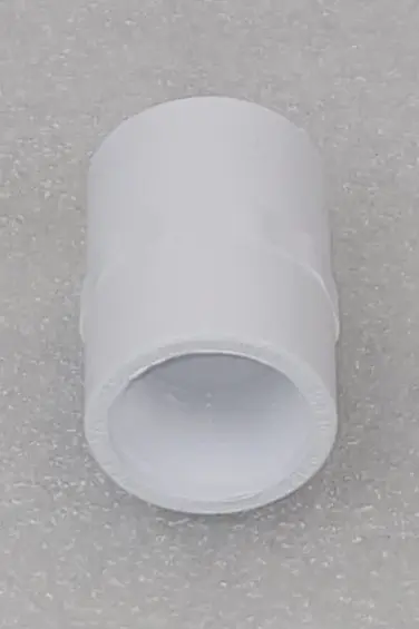 A white tube is sitting on the ground.