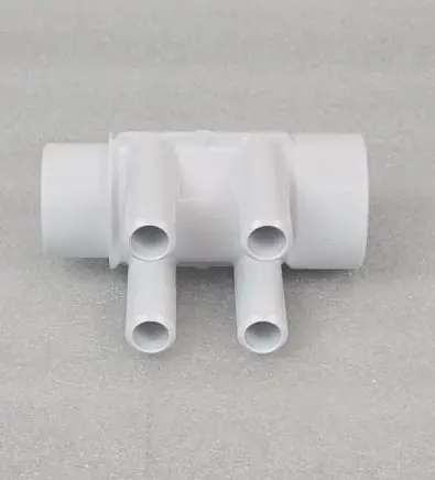 A white pipe with four pipes on it.