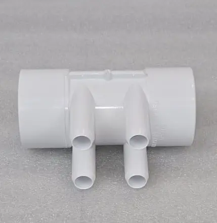A white pipe with two pipes connected to it.