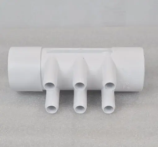 A white pipe with four pipes connected to it.