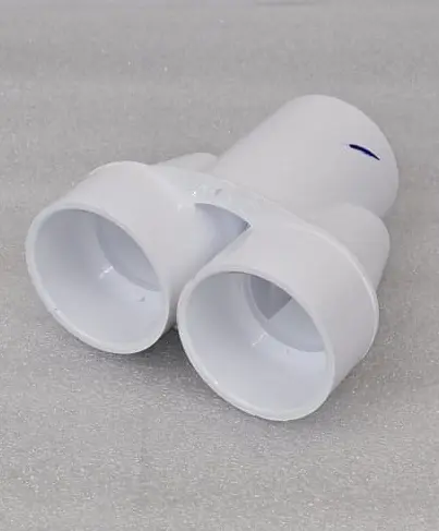 A white pipe sitting on top of the floor.
