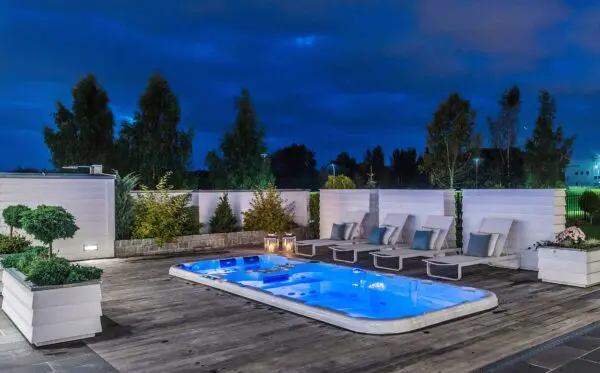 A large hot tub sitting on top of a wooden deck.
