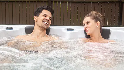 A man and woman in the hot tub.
